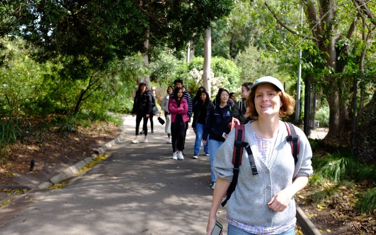 Corporate group walking in field
